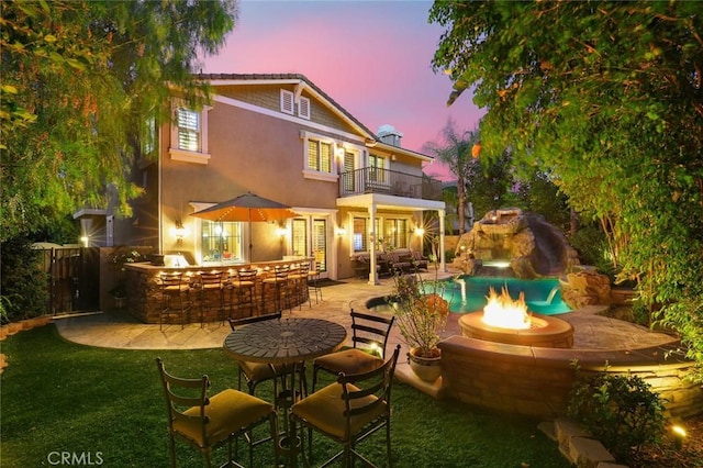 3973 Coast Oak Cir, Chino Hills, CA 91709 - rear view of house with outdoor dry bar, a balcony, stucco siding, a patio area, and an outdoor fire pit