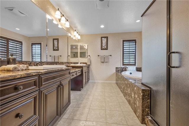 3973 Coast Oak Cir, Chino Hills, CA 91709 - full bathroom featuring a sink, double vanity, baseboards, tile patterned flooring, and a garden tub