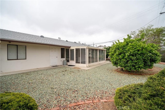 28890 Snead Dr, Menifee, CA 92586 - rear view of property featuring a sunroom, a shingled roof, and stucco siding