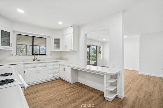 28890 Snead Dr, Menifee, CA 92586 - kitchen with light countertops, open shelves, light wood finished floors, and a sink