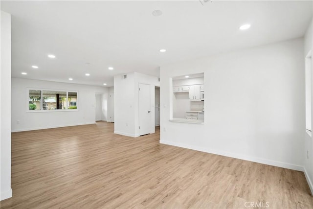 28890 Snead Dr, Menifee, CA 92586 - unfurnished living room featuring recessed lighting, baseboards, and light wood-style floors
