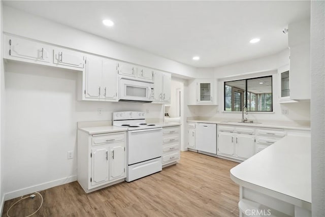 28890 Snead Dr, Menifee, CA 92586 - kitchen with light wood-type flooring, a sink, white cabinetry, and white appliances