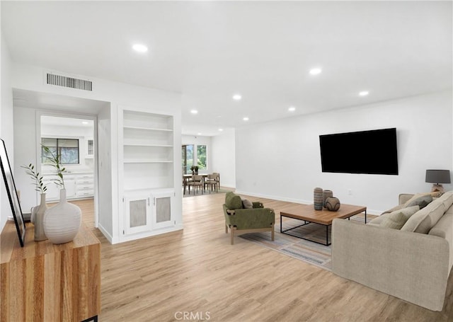 28890 Snead Dr, Menifee, CA 92586 - living area with visible vents, built in shelves, light wood finished floors, and recessed lighting