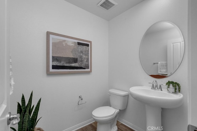 8000 7th St, Downey, CA 90241 - bathroom featuring toilet, visible vents, wood finished floors, and baseboards