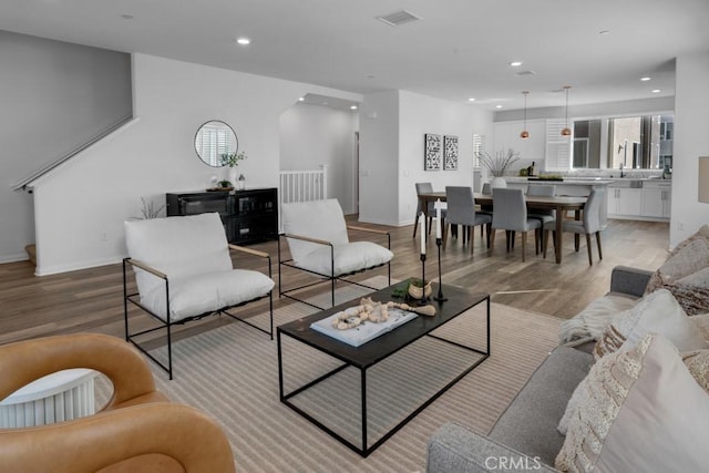 8000 7th St, Downey, CA 90241 - living area featuring light wood finished floors, visible vents, baseboards, and recessed lighting