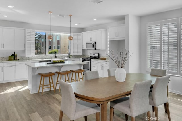8000 7th St, Downey, CA 90241 - dining room with recessed lighting, plenty of natural light, visible vents, and light wood-type flooring