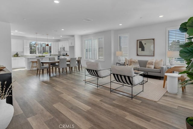 8000 7th St, Downey, CA 90241 - living room with light wood-style floors, visible vents, and recessed lighting