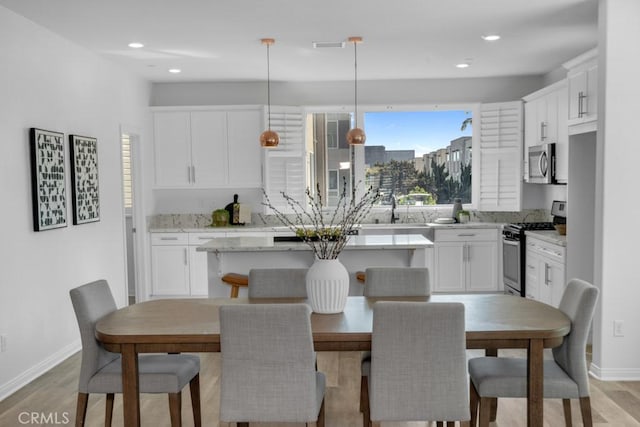8000 7th St, Downey, CA 90241 - dining room featuring light wood-style flooring, baseboards, and recessed lighting