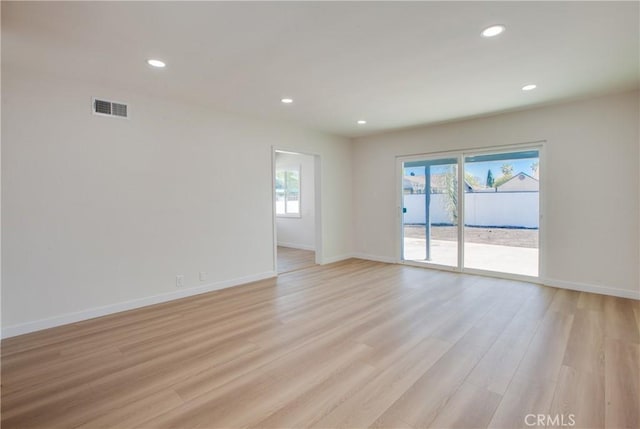 spare room with light wood-style floors, recessed lighting, visible vents, and baseboards