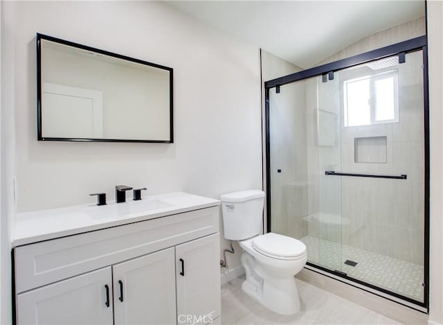 bathroom featuring toilet, a stall shower, lofted ceiling, and vanity