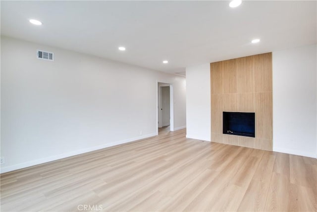 unfurnished living room with visible vents, light wood-type flooring, and recessed lighting