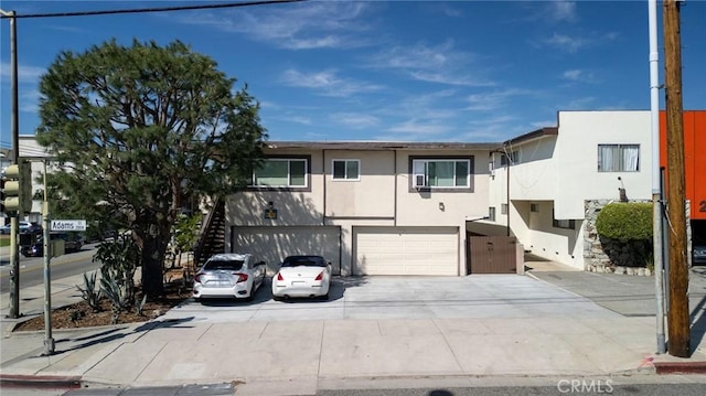 1015 E Wilson Ave, Glendale, CA 91206 - view of front of house with stucco siding, a garage, and driveway