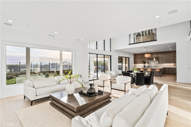 living room featuring light wood finished floors and recessed lighting