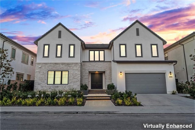 modern inspired farmhouse with a garage, driveway, and stucco siding