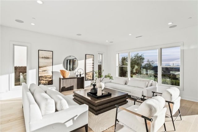 living area featuring recessed lighting and light wood finished floors
