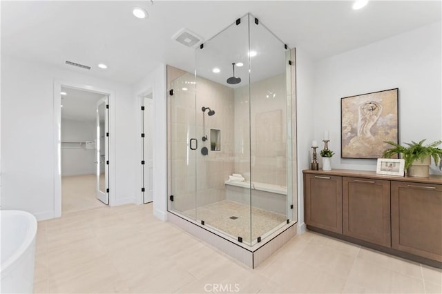full bath with a soaking tub, a shower stall, visible vents, recessed lighting, and baseboards