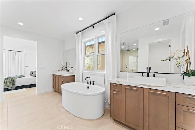 bathroom with visible vents, a sink, a soaking tub, recessed lighting, and two vanities