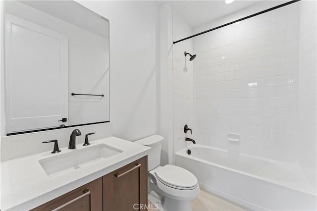 bathroom featuring vanity, shower / tub combination, and toilet