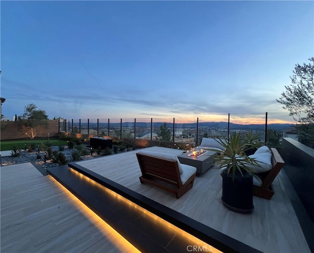 deck at dusk with a fire pit