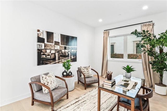 sitting room with light wood-type flooring, baseboards, and recessed lighting