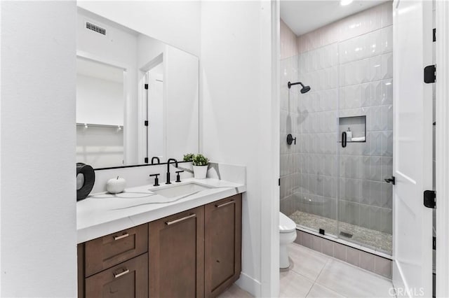 bathroom with vanity, a stall shower, tile patterned flooring, toilet, and visible vents