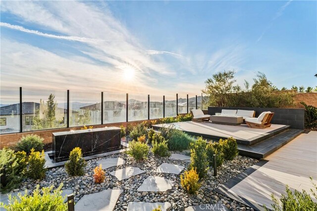 view of patio / terrace with an outdoor living space, fence, and a wooden deck