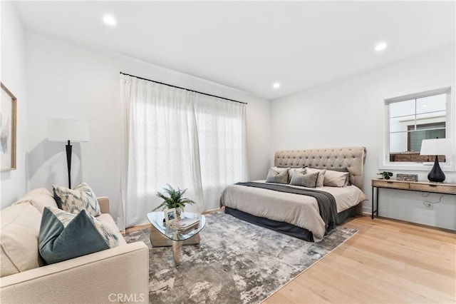 bedroom with recessed lighting and wood finished floors