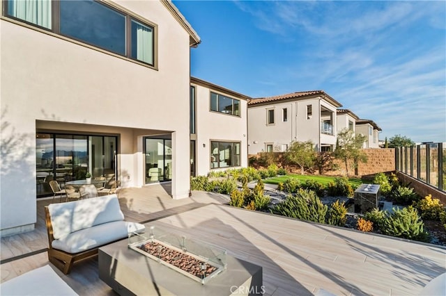 view of patio / terrace with an outdoor fire pit and fence
