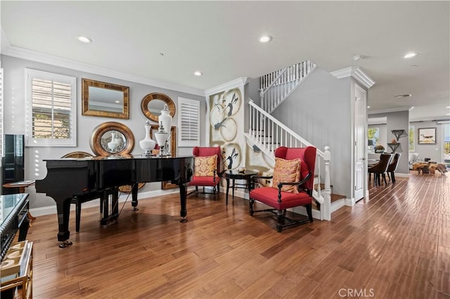 sitting room with recessed lighting, stairway, and crown molding