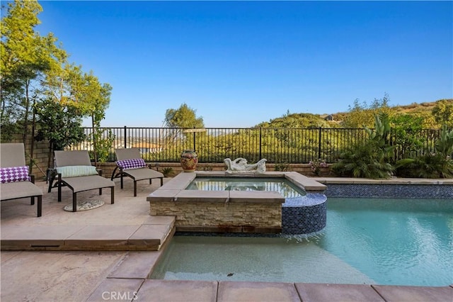 view of swimming pool with a patio area, a fenced backyard, an in ground hot tub, and a fenced in pool