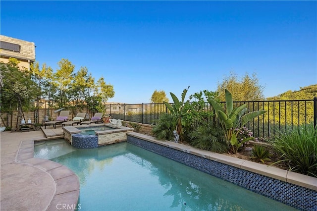 view of pool with a patio area, a pool with connected hot tub, and a fenced backyard