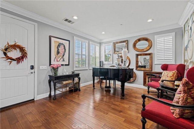 sitting room featuring visible vents, baseboards, crown molding, recessed lighting, and wood finished floors