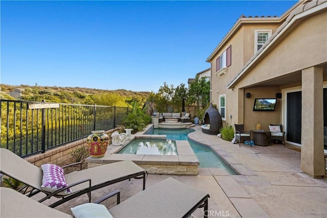 view of pool with outdoor lounge area, a patio, a fenced backyard, and a fenced in pool