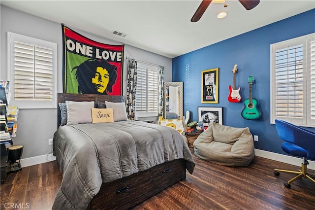 bedroom featuring visible vents, baseboards, a ceiling fan, and wood finished floors