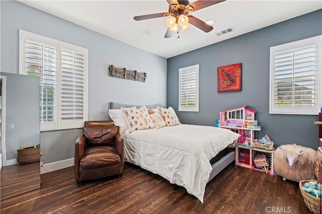 bedroom with visible vents, ceiling fan, wood finished floors, and baseboards
