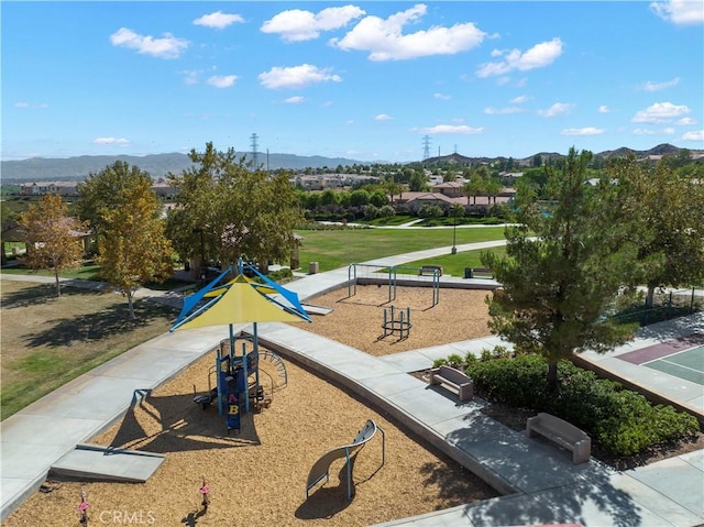surrounding community featuring a mountain view and playground community