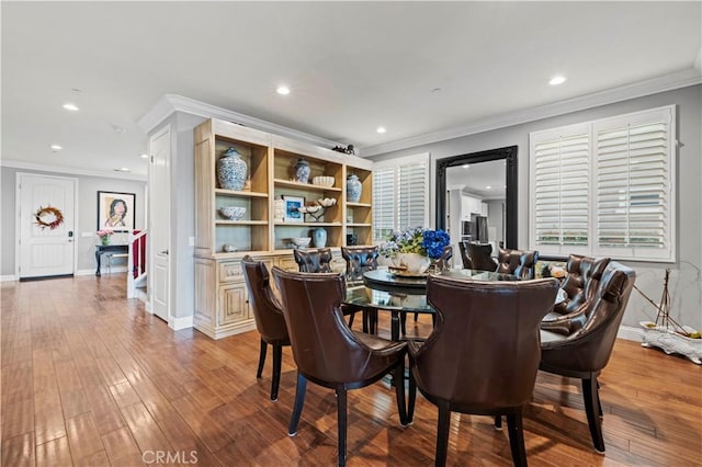 dining space featuring baseboards, ornamental molding, and recessed lighting