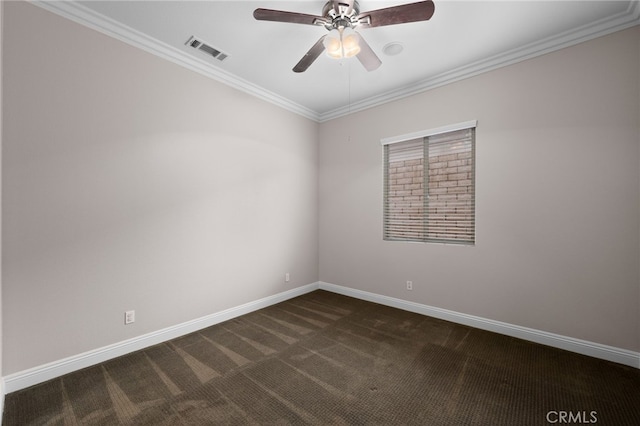 spare room featuring dark carpet, visible vents, ceiling fan, baseboards, and ornamental molding
