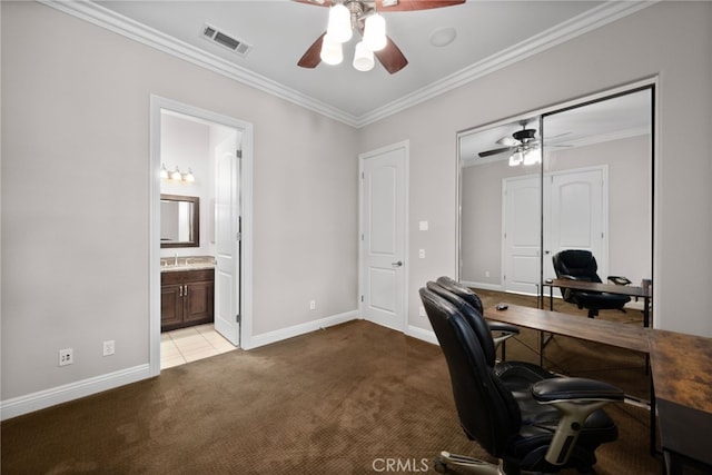 home office with crown molding, a ceiling fan, visible vents, light carpet, and baseboards