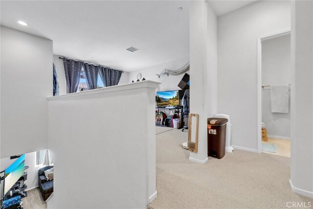 hall with carpet flooring, baseboards, and recessed lighting