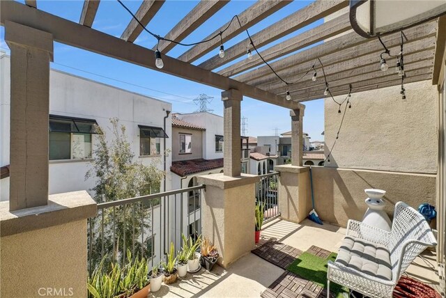view of patio with a balcony and a pergola