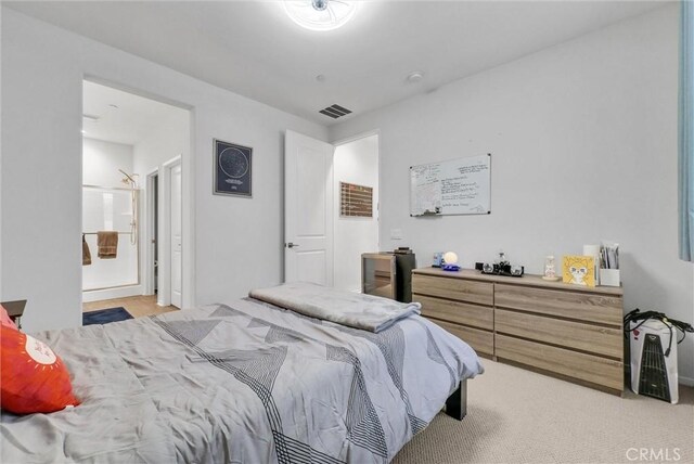 bedroom featuring light colored carpet