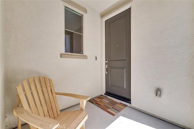 doorway to property with stucco siding