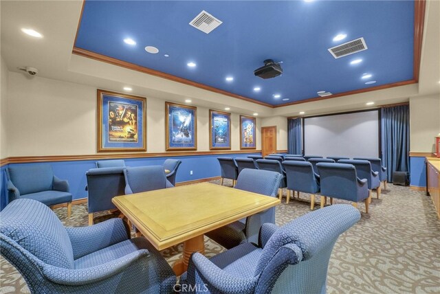 cinema featuring a tray ceiling, recessed lighting, baseboards, and crown molding