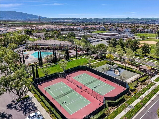 aerial view of a mountainous background and a pool area