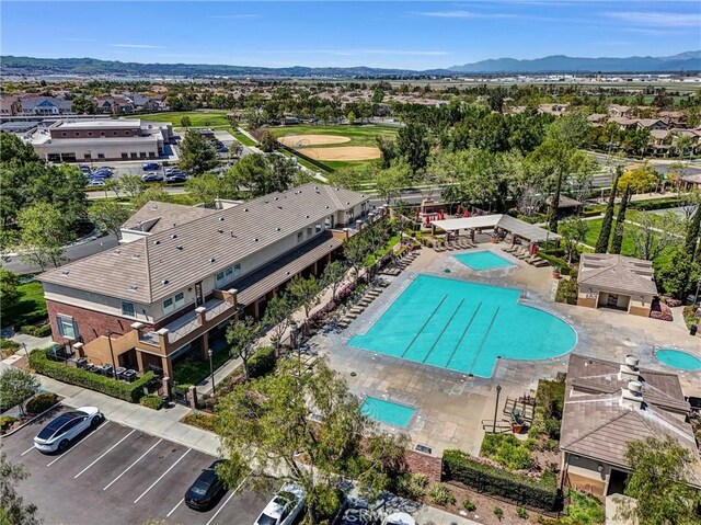 drone / aerial view of a pool area and a mountainous background