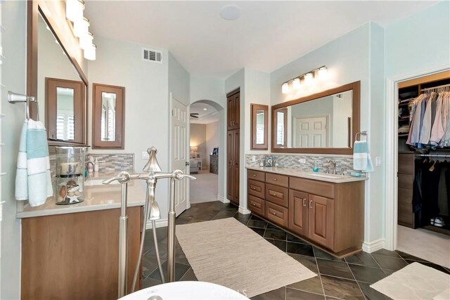 6288 Sunnyside Cir, Huntington Beach, CA 92648 - bathroom featuring tasteful backsplash, vanity, tile patterned flooring, visible vents, and a walk in closet