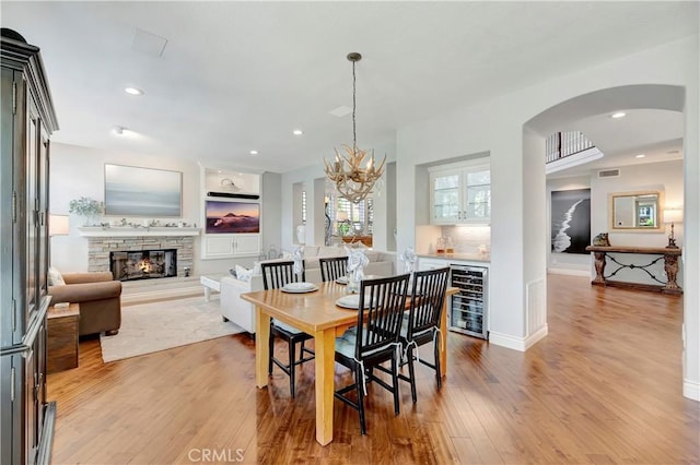 6288 Sunnyside Cir, Huntington Beach, CA 92648 - dining area featuring wine cooler, recessed lighting, a fireplace, and light wood-type flooring