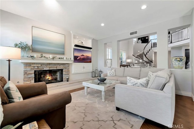 6288 Sunnyside Cir, Huntington Beach, CA 92648 - living area featuring visible vents, a stone fireplace, recessed lighting, and wood finished floors