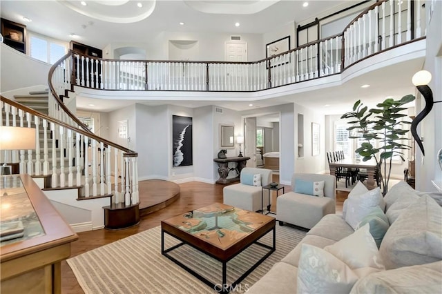 6288 Sunnyside Cir, Huntington Beach, CA 92648 - living room featuring baseboards, recessed lighting, a high ceiling, stairs, and wood finished floors